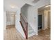 Inviting hallway with wood floors, stairs and view of the mudroom at 7129 Dove Field Ln, Fort Mill, SC 29707
