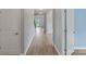 Bright hallway with hardwood floors leading to staircase and other rooms at 7129 Dove Field Ln, Fort Mill, SC 29707