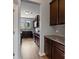 Well-lit kitchen with dark wood cabinets, granite countertops and stainless steel appliances at 7129 Dove Field Ln, Fort Mill, SC 29707