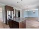 Open kitchen with a center island, stainless steel appliances, and access to a living room at 7129 Dove Field Ln, Fort Mill, SC 29707