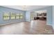 Bright living room with hardwood floors, large windows, and view to the kitchen at 7129 Dove Field Ln, Fort Mill, SC 29707