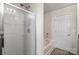 Bright bathroom featuring a glass-enclosed shower, a soaking tub, and a white door at 7136 Bullock Dr, Charlotte, NC 28214