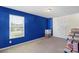 Bright bedroom with a large window, neutral carpet, and white closet doors at 7136 Bullock Dr, Charlotte, NC 28214
