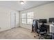 Neutral bedroom featuring carpeted floors, natural light, and a modern workstation set up at 7136 Bullock Dr, Charlotte, NC 28214