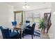 Inviting dining room with a glass table, comfortable blue chairs, and stylish decor at 7136 Bullock Dr, Charlotte, NC 28214