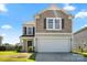 Charming two-story home with neutral siding, an attached garage, and a well-maintained lawn at 7136 Bullock Dr, Charlotte, NC 28214