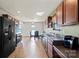 Kitchen with wooden cabinets and black appliances, with space for an eat-in dining table at 7136 Bullock Dr, Charlotte, NC 28214