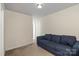 Carpeted living room with a blue sofa and neutral-colored walls, offering a cozy and versatile space at 7136 Bullock Dr, Charlotte, NC 28214
