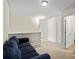 View of a carpeted living room showing a partial view of a blue sofa near an open doorway at 7136 Bullock Dr, Charlotte, NC 28214