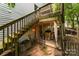 Backyard patio with stairs to deck and covered area with outdoor kitchen at 7218 Cascading Pines Dr, Fort Mill, SC 29708