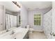 Well-lit bathroom featuring a vanity sink and shower curtain, complemented by neutral walls at 7218 Cascading Pines Dr, Fort Mill, SC 29708