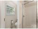 Neat bathroom featuring a glass-enclosed shower, complemented by a window and functional toilet area at 7218 Cascading Pines Dr, Fort Mill, SC 29708