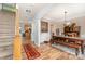 A dining room features hardwood floors, a rustic wooden table with bench seating, and decorative accents at 7218 Cascading Pines Dr, Fort Mill, SC 29708