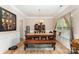 Dining room boasts hardwood floors, a rustic table with seating, and a large window with natural light at 7218 Cascading Pines Dr, Fort Mill, SC 29708