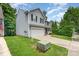 An eye-level shot of a two-story home with light siding and a green lawn, showcasing the side of the property at 7218 Cascading Pines Dr, Fort Mill, SC 29708