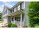 A cozy front porch features a seating area, columns, and landscaping, inviting relaxation and curb appeal at 7218 Cascading Pines Dr, Fort Mill, SC 29708