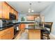 A kitchen featuring wooden cabinets, granite countertops, stainless appliances, and an island with bar stool seating at 7218 Cascading Pines Dr, Fort Mill, SC 29708