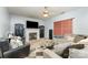 A comfortable living room features a fireplace, a ceiling fan, neutral tones, and ample seating for relaxation at 7218 Cascading Pines Dr, Fort Mill, SC 29708