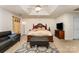 Spacious main bedroom with a tray ceiling, complemented by a cozy sitting area and elegant decor at 7218 Cascading Pines Dr, Fort Mill, SC 29708