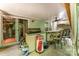 Covered patio with outdoor kitchen and bar area with ceiling fan and dining chairs at 7218 Cascading Pines Dr, Fort Mill, SC 29708