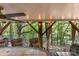 Covered patio featuring outdoor dining and ceiling fan with view of wooded backyard at 7218 Cascading Pines Dr, Fort Mill, SC 29708