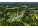 Expansive aerial view showing the neighborhood nestled amongst abundant mature trees and lush green spaces at 8032 Joy Crossing Ln, Charlotte, NC 28214