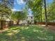 Beautiful backyard featuring a lush green lawn and privacy fence at 911 Munday Ct, Charlotte, NC 28270