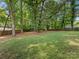 Expansive backyard with a mix of grass and wooded areas and privacy fence at 911 Munday Ct, Charlotte, NC 28270