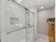 Modern bathroom with a glass enclosed shower and convenient storage shelves at 911 Munday Ct, Charlotte, NC 28270