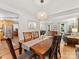 Open concept dining room features a wood table and is adjacent to the living room and kitchen at 911 Munday Ct, Charlotte, NC 28270