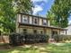 Two-story home with a charming covered front porch, mature landscaping, and a well-maintained lawn at 911 Munday Ct, Charlotte, NC 28270