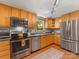 Kitchen with stainless steel appliances, granite countertops, and wood cabinets is perfect for entertaining guests at 911 Munday Ct, Charlotte, NC 28270