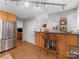 Kitchen with granite countertops, a breakfast bar, stainless steel appliances, and wood cabinets at 911 Munday Ct, Charlotte, NC 28270