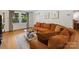 Living room with a brown couch, windows, and hardwood floors. Perfect for entertaining guests at 911 Munday Ct, Charlotte, NC 28270