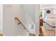 Staircase featuring wood railing and leading to the main level with bedroom view at 911 Munday Ct, Charlotte, NC 28270