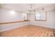 Spacious basement area with wood-look flooring, recessed lighting, and windows allowing natural light at 9117 Castle Garden Ln, Charlotte, NC 28215