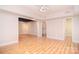Spacious finished basement features light-toned wood floors and neutral colored walls at 9117 Castle Garden Ln, Charlotte, NC 28215