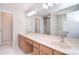 Bathroom with double sink vanity with granite countertop and large mirror at 9117 Castle Garden Ln, Charlotte, NC 28215