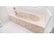 Bathroom features a marble jacuzzi tub with tile surround and tile floors at 9117 Castle Garden Ln, Charlotte, NC 28215