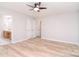 Bright bedroom features an ensuite bathroom, closet and wood floors at 9117 Castle Garden Ln, Charlotte, NC 28215