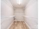 Walk-in closet with adjustable wire shelving and wood floors at 9117 Castle Garden Ln, Charlotte, NC 28215