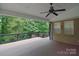 View of covered deck with ceiling fan at 9117 Castle Garden Ln, Charlotte, NC 28215