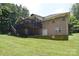 Exterior of home featuring brick, deck, patio, and spacious backyard with green lawn at 9117 Castle Garden Ln, Charlotte, NC 28215