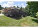 Home exterior showcasing a spacious deck, backyard, and mature landscaping at 9117 Castle Garden Ln, Charlotte, NC 28215