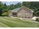 Well-maintained brick home with an attached garage, neat landscaping and freshly cut lawn at 9117 Castle Garden Ln, Charlotte, NC 28215