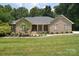 Charming brick home featuring a well-manicured lawn and inviting front porch with meticulous landscaping at 9117 Castle Garden Ln, Charlotte, NC 28215