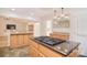 Kitchen featuring island cooktop, granite countertops, and view to the living room at 9117 Castle Garden Ln, Charlotte, NC 28215