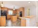 Traditional kitchen features tile floors, granite counters, wood cabinets, and a center island at 9117 Castle Garden Ln, Charlotte, NC 28215