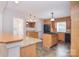 Kitchen featuring tile floors, granite counters, center island, and exterior door at 9117 Castle Garden Ln, Charlotte, NC 28215