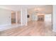 Bright, open living room with wood floors, brick fireplace, and view of staircase to another level at 9117 Castle Garden Ln, Charlotte, NC 28215
